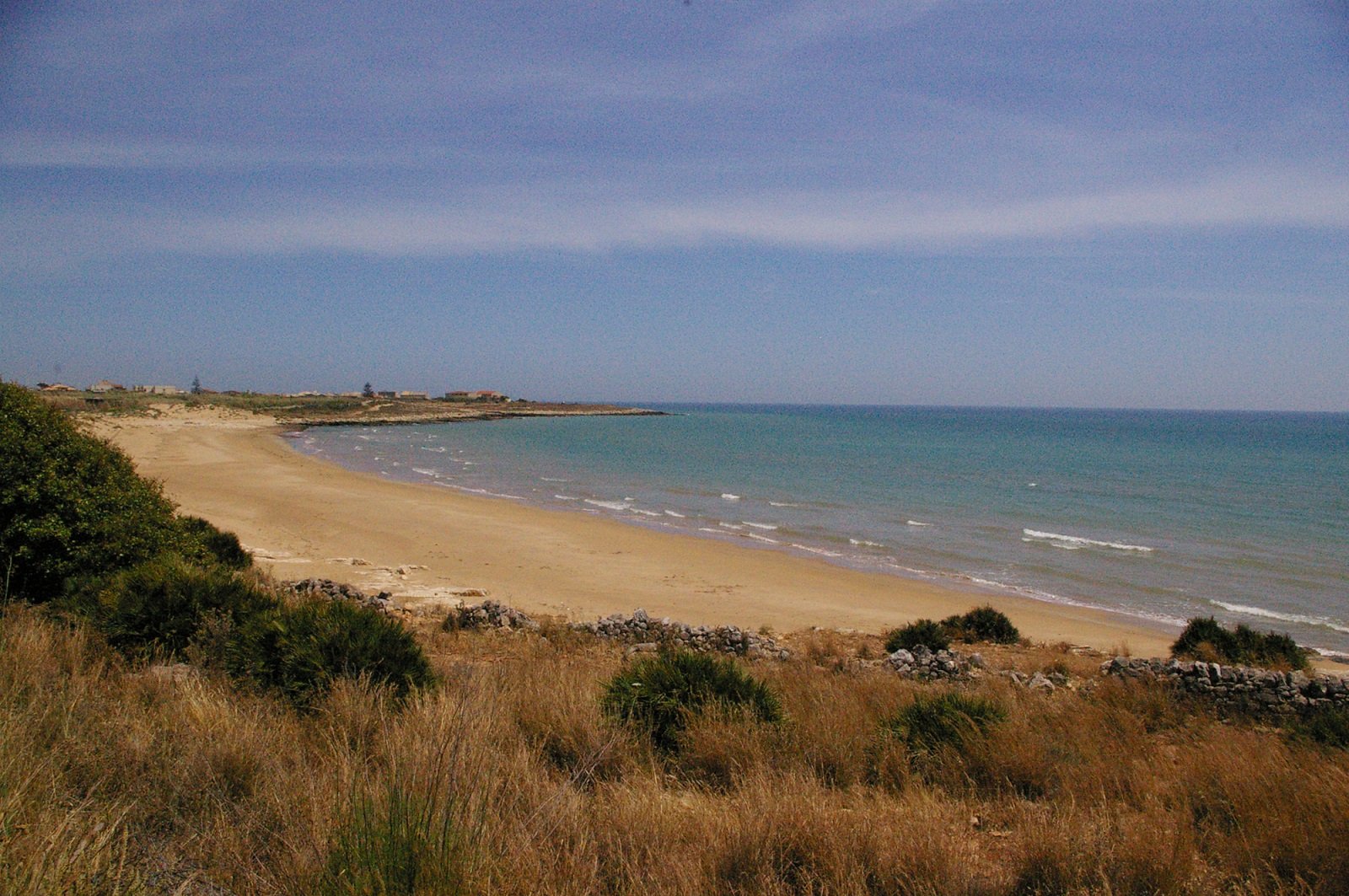 The wide golden sandy beach of Micenci in Donnalucata, with its lively seafront.